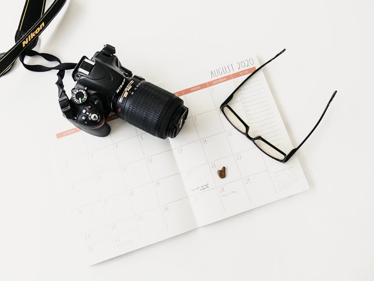 black nikon dslr camera on white paper