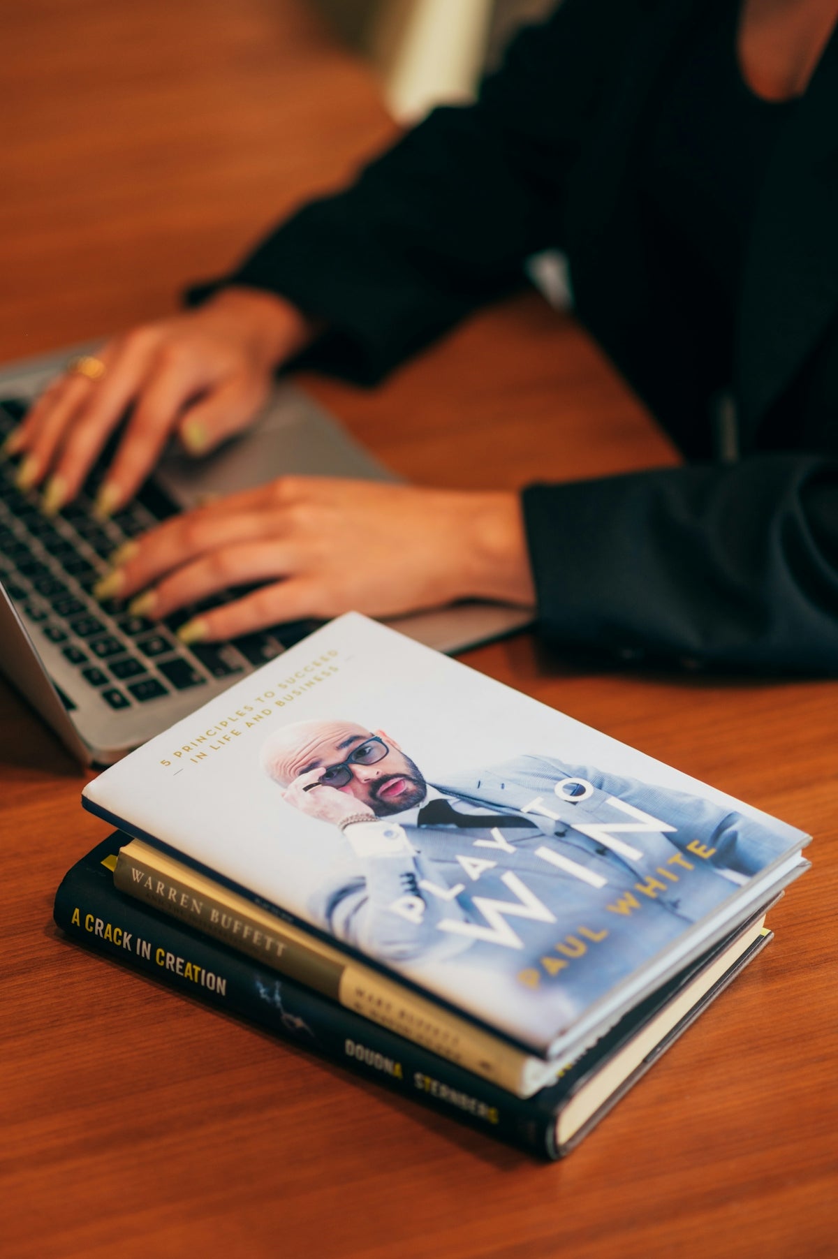 person in black jacket using macbook pro