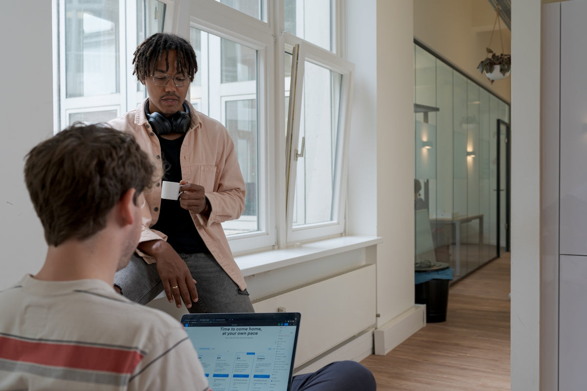 man in white dress shirt sitting on chair