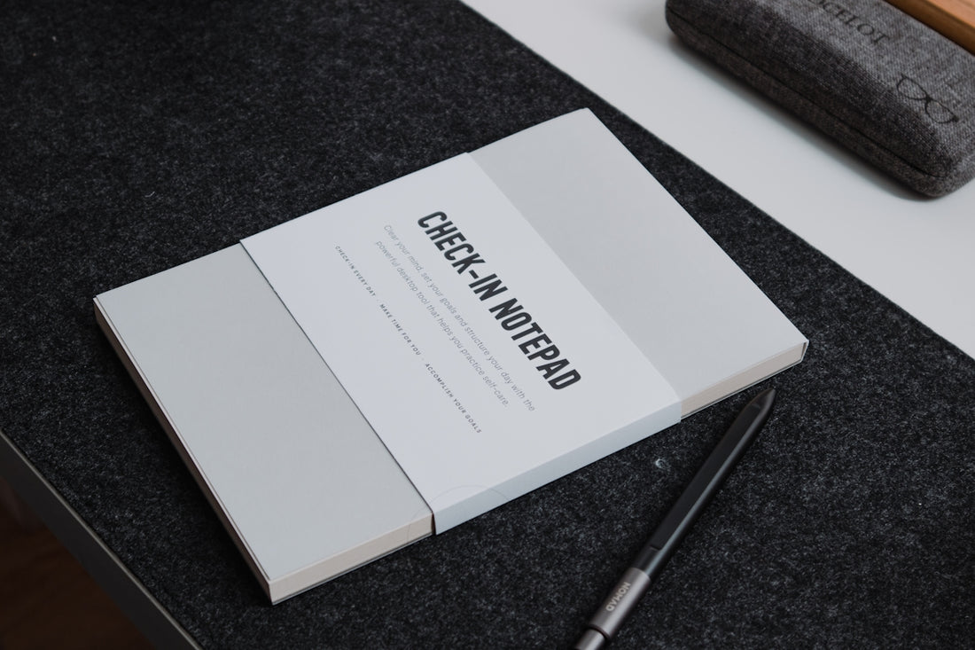 a book sitting on top of a table next to a pen