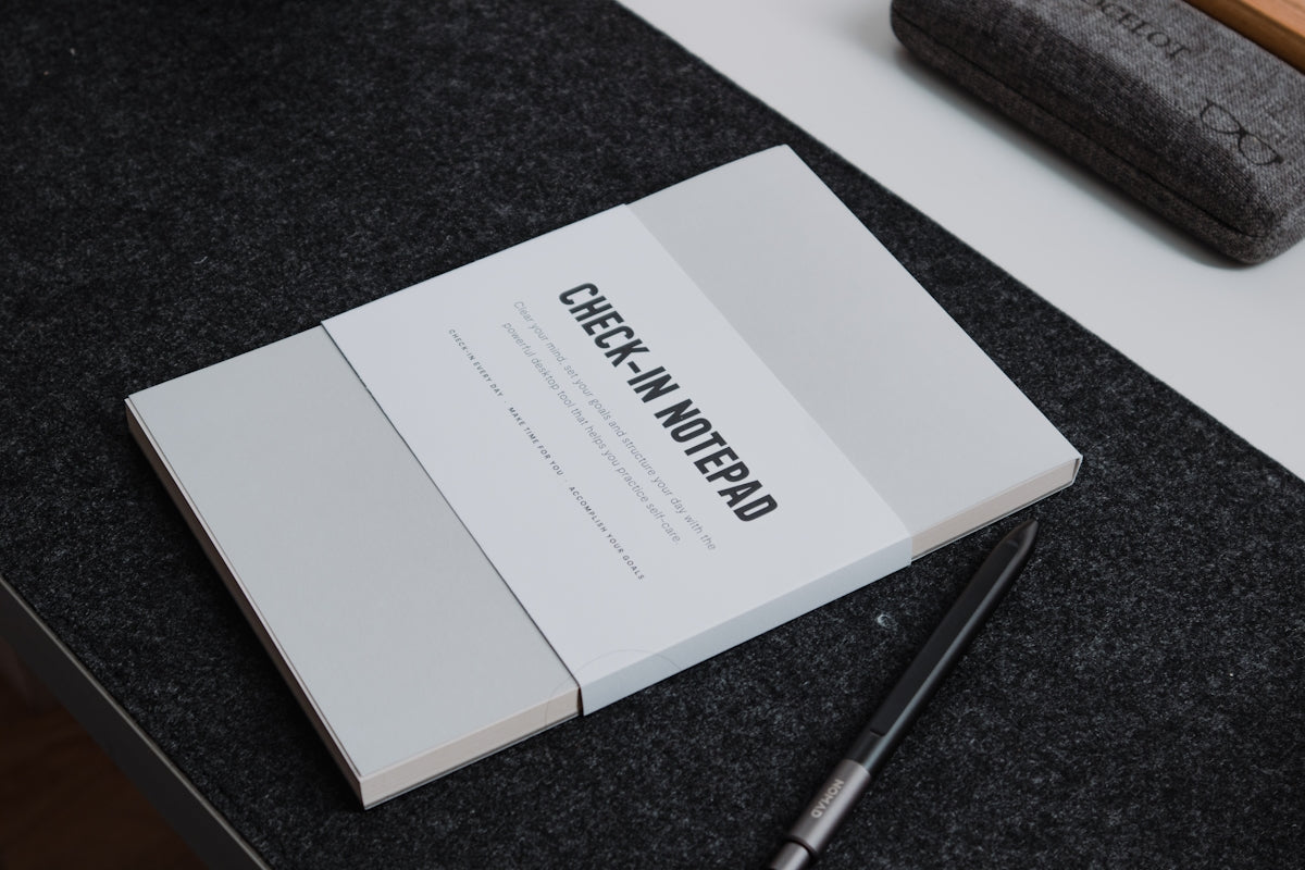 a book sitting on top of a table next to a pen